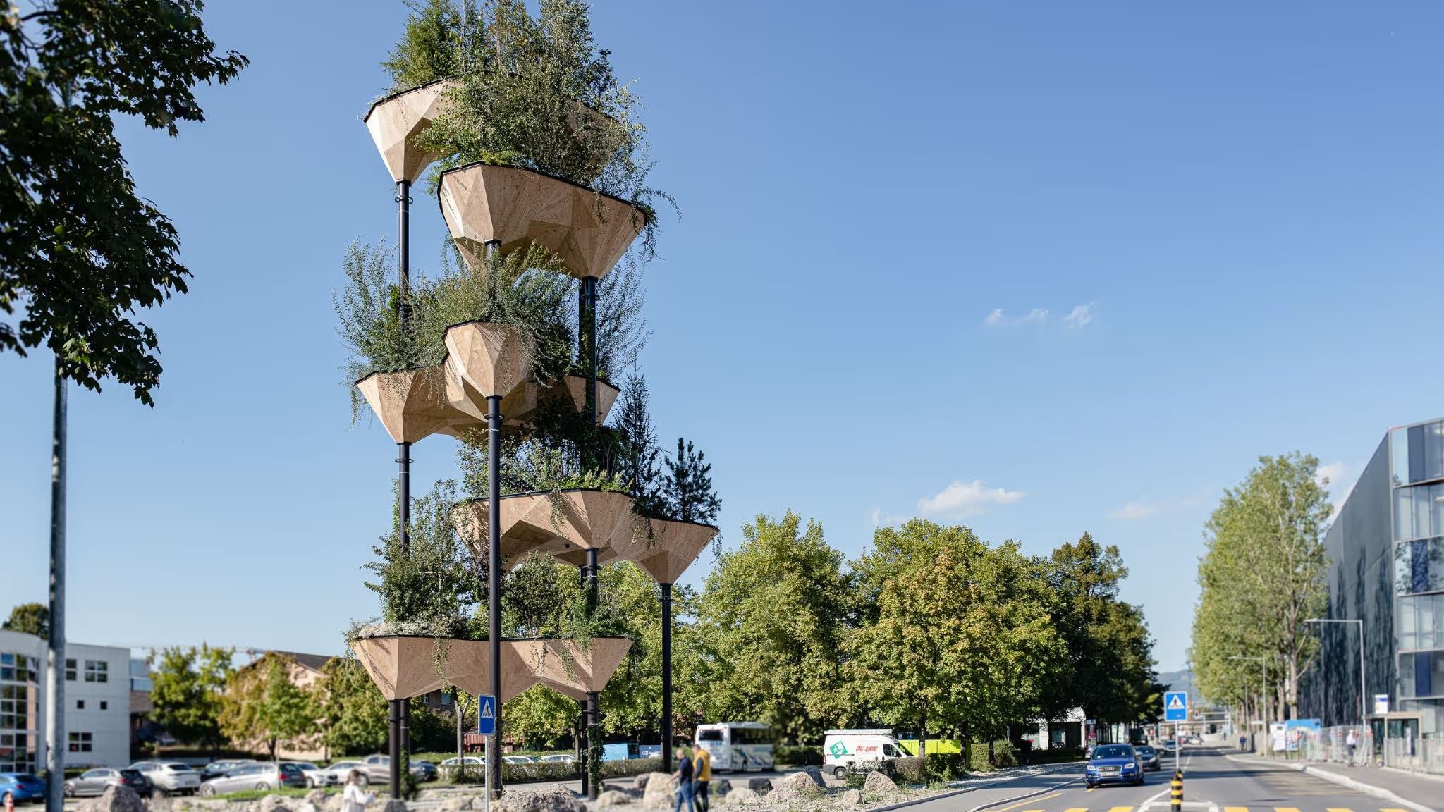 Timber planter pods stacked on slender columns above a street, planted with trees and shrubs